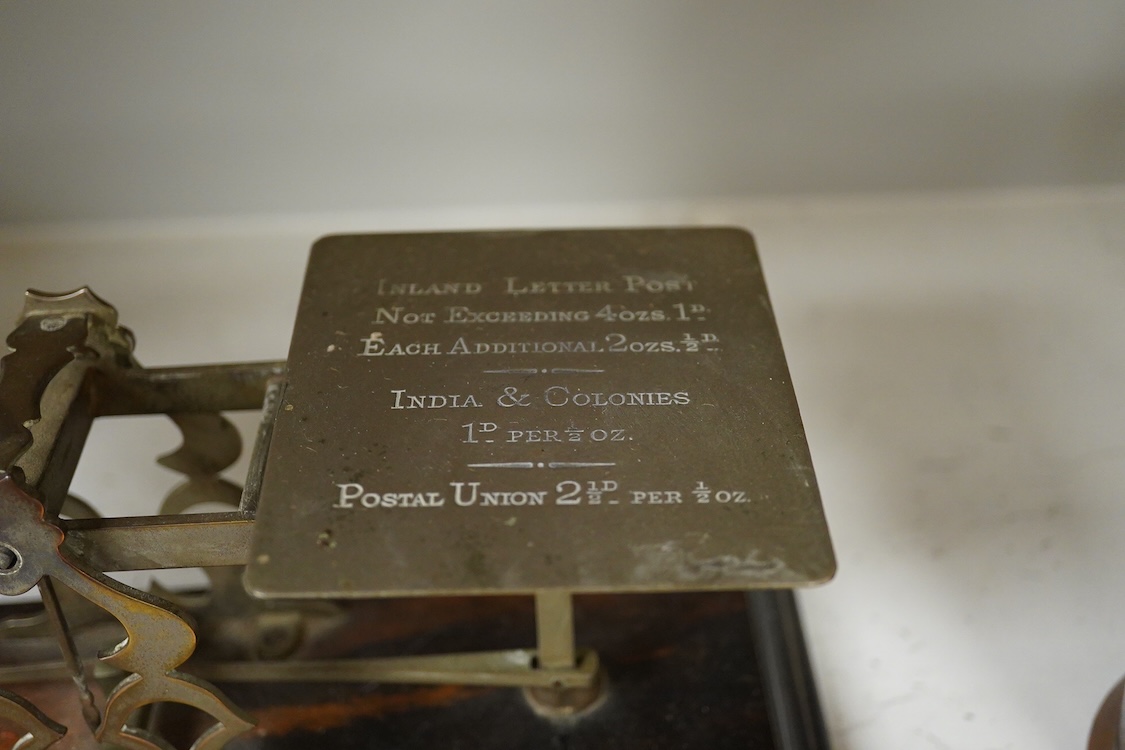 A collection of items to include a leather cased gilt brass French carriage clock, a German bronze Jugendstil inkwell, a late 19th century ink brass inkwell, a set of postal scales with weights, a Temple & Crook small co